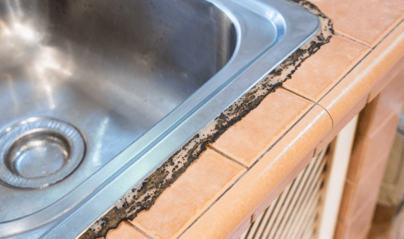 Mildew buildup around sink caulking.