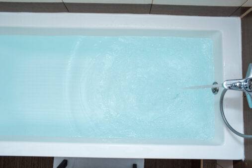 Blue water in the bath. Bathroom. Top view.