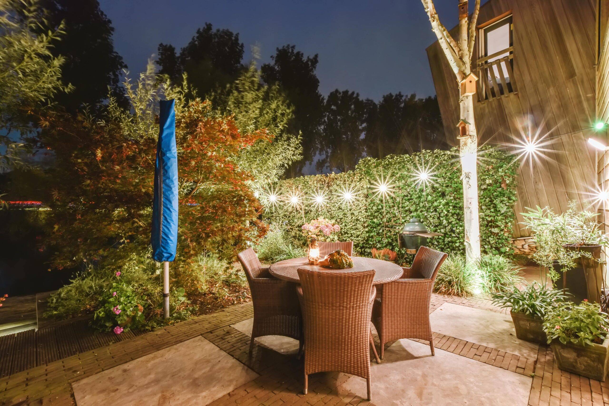 A home's backyard with bright, bright string lighting.