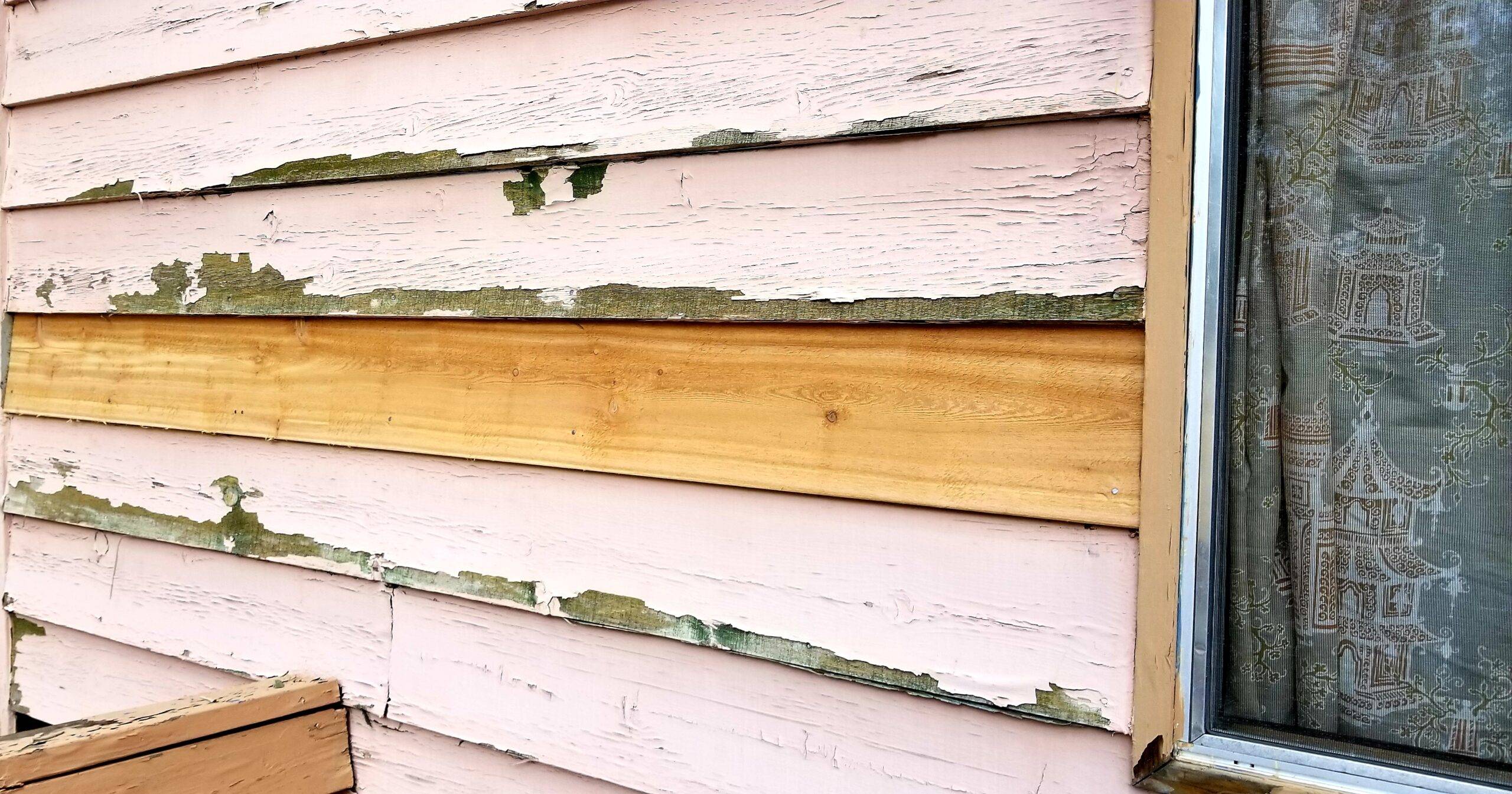 Peeling paint on a home's siding.