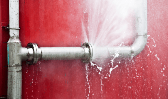 A burst pipe that's spraying water.