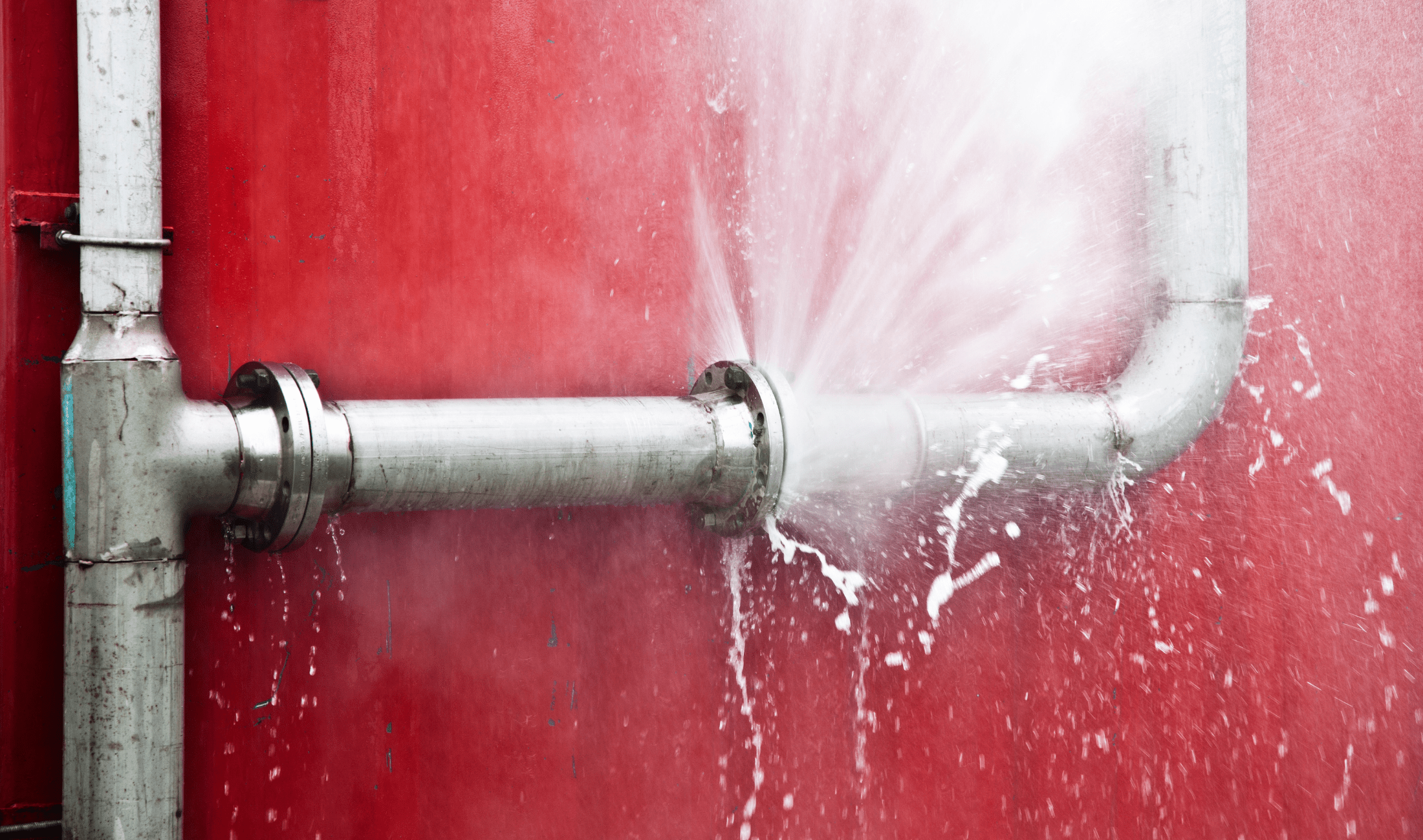 A burst pipe that's spraying water.