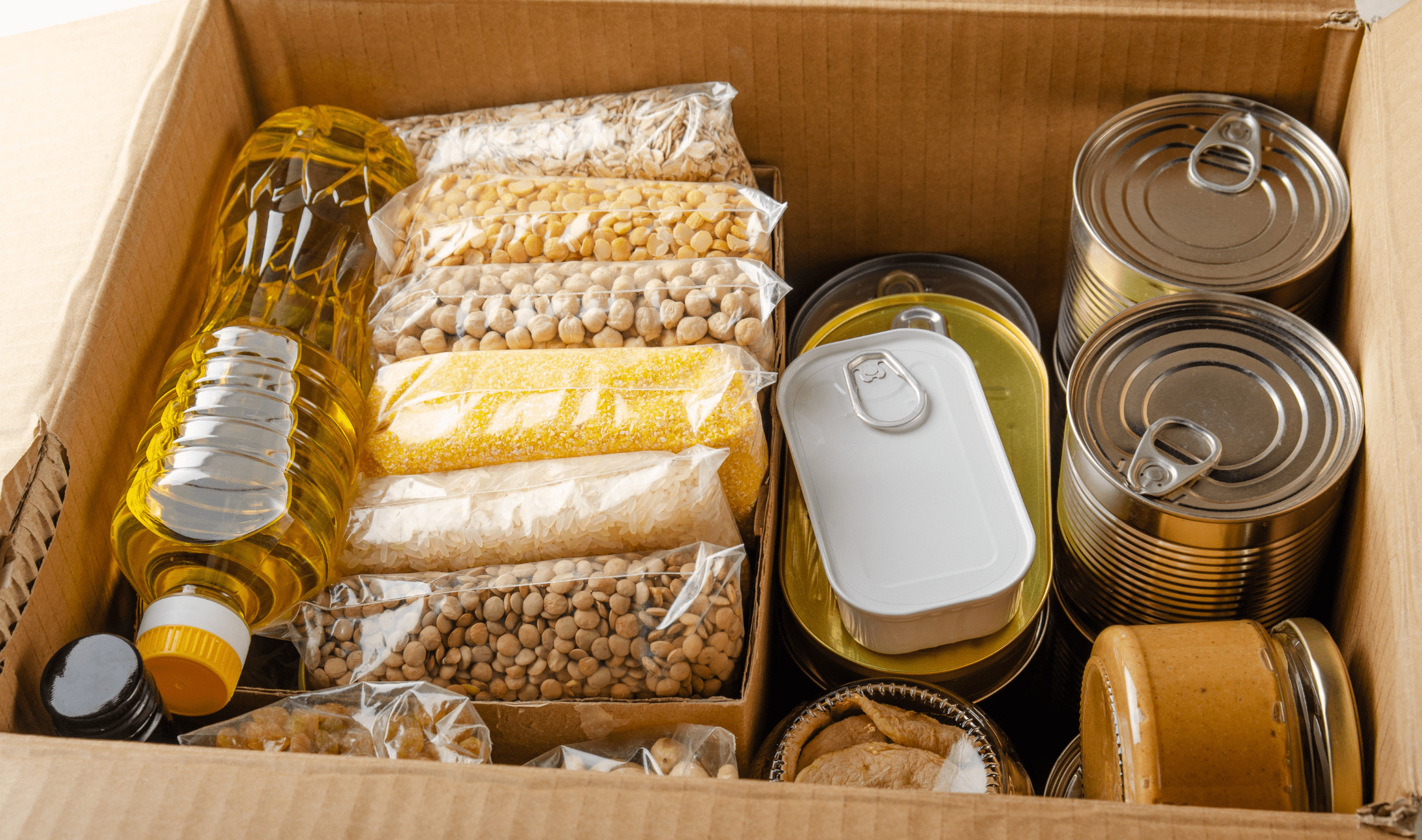 A box full of canned and other non-perishable goods.