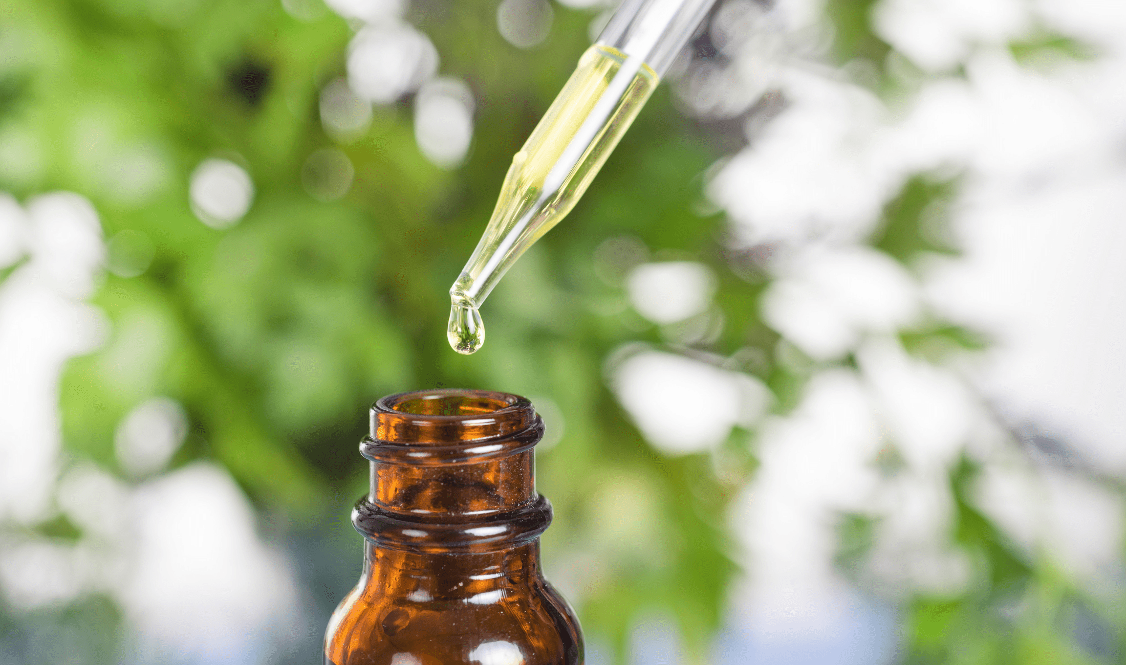 A closeup of a dropper of essential oil.