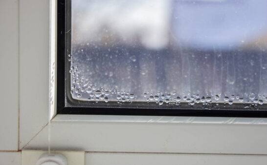Close-up of condensation on a PVC window, white plastic window, humidity concept