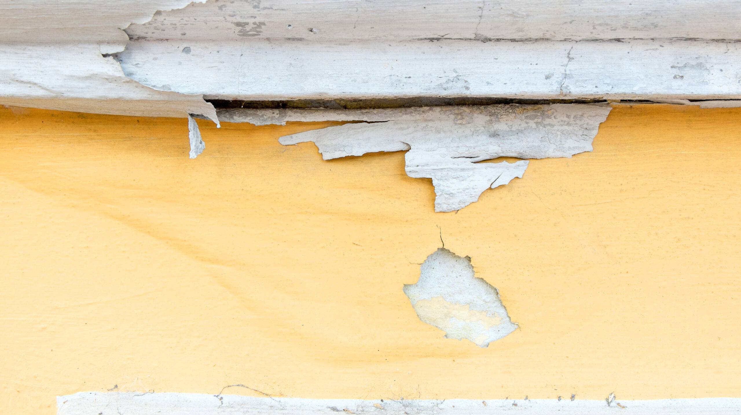 yellow erode painted concrete wall,grunge rough texture background.