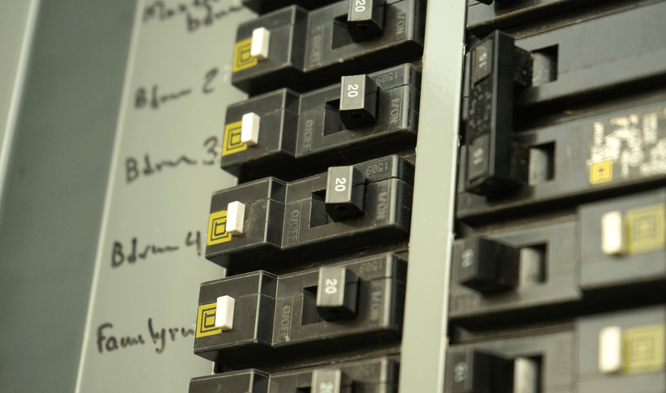 A closeup of a few labeled switches on a breaker box.