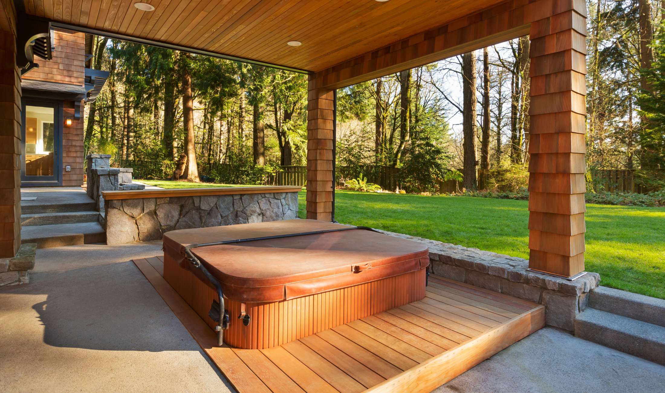 A hot tub built in, and semi-sunk, to a backyard deck.