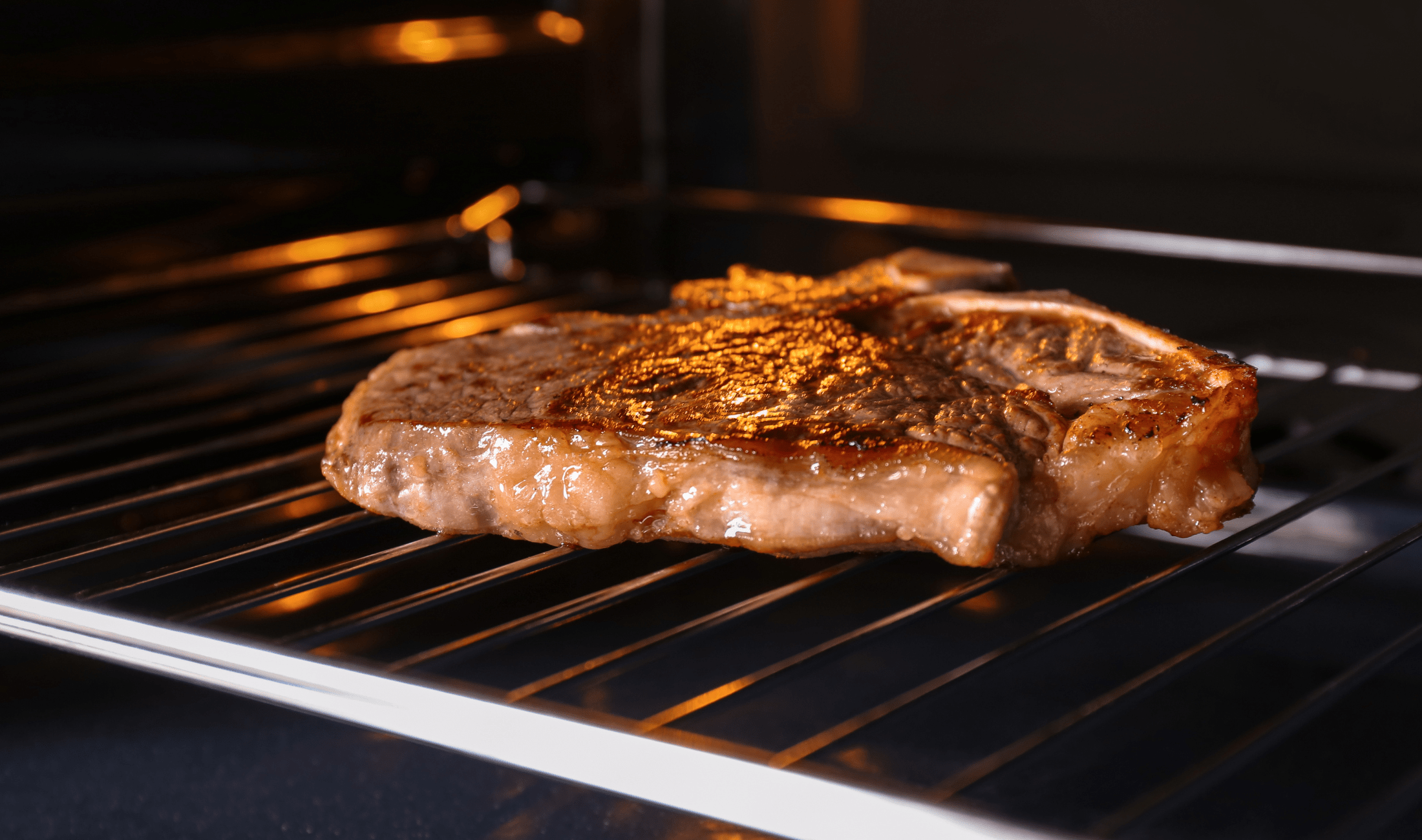 A steak on an oven rack.