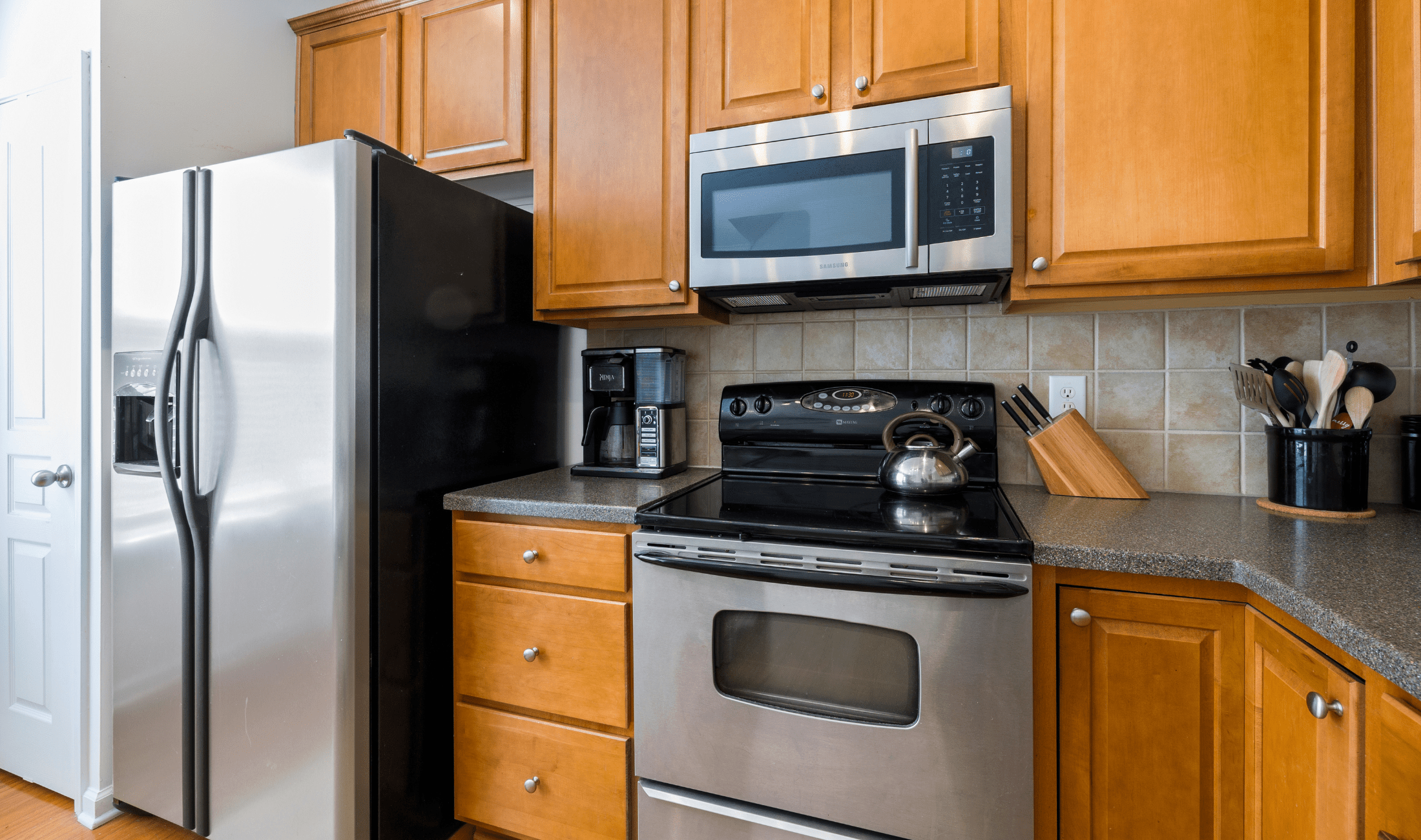 A kitchen with a built in microwave hutch above the stove.