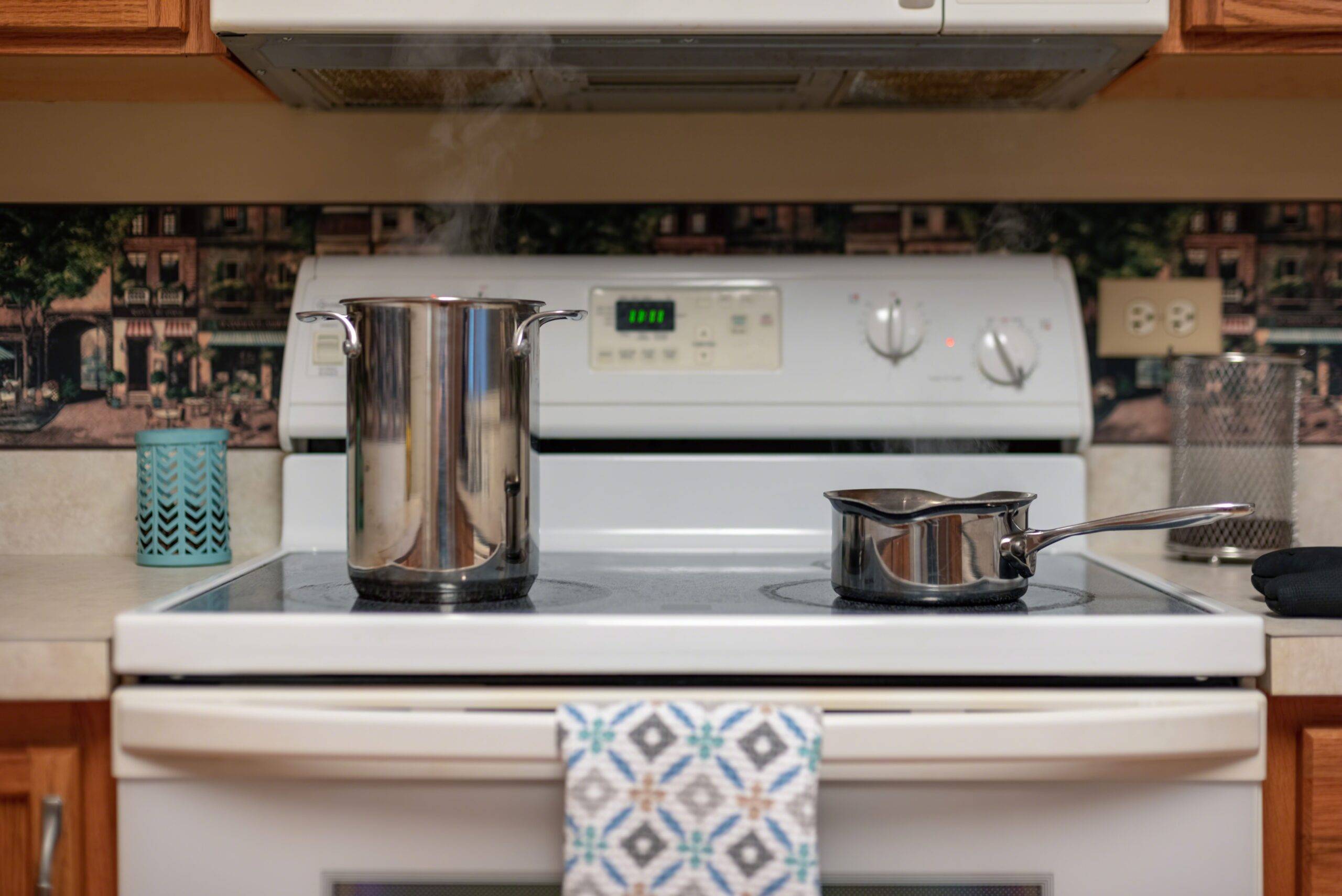 Steam rising out of cooking pots on the stove