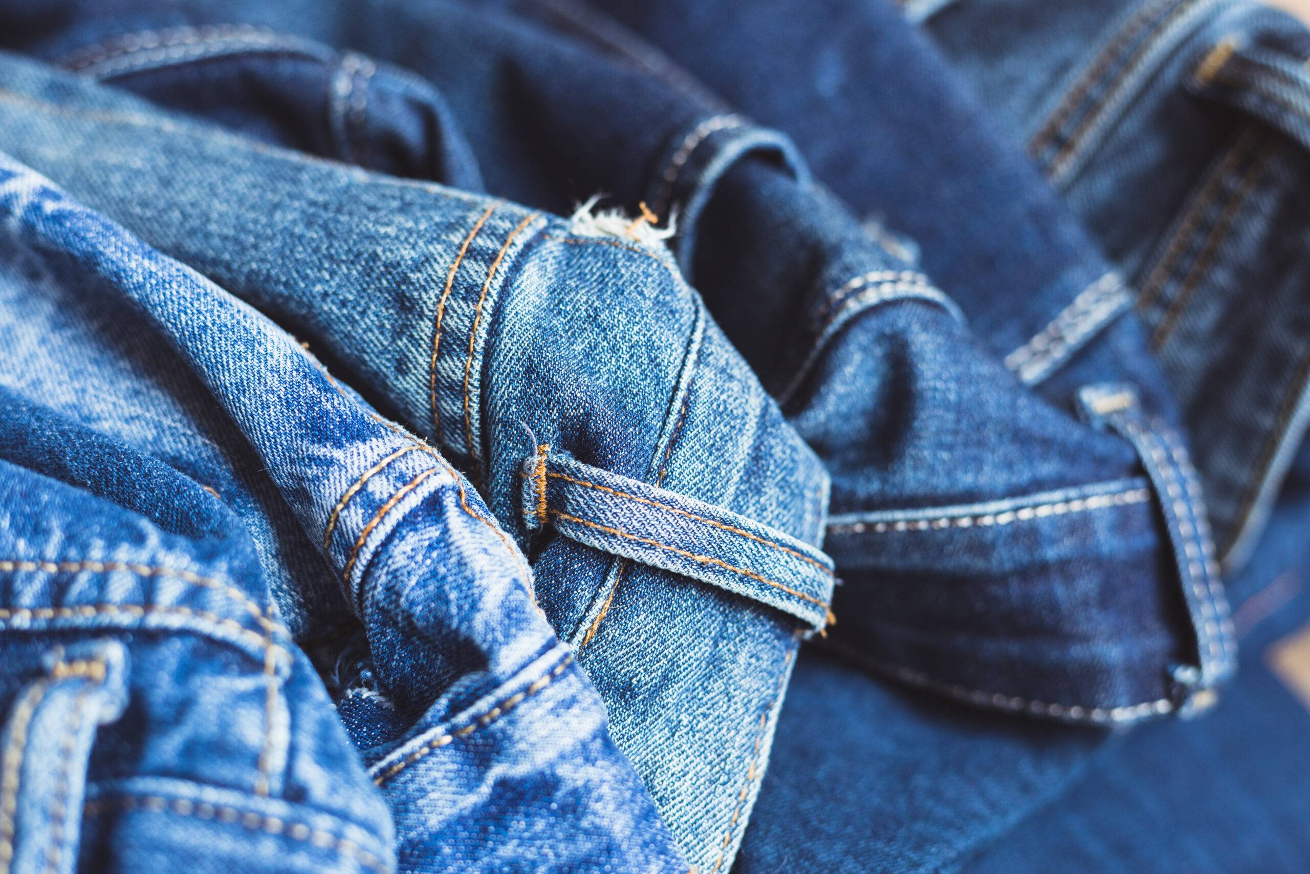 A closeup of denim fabric, some light and some dark blue.