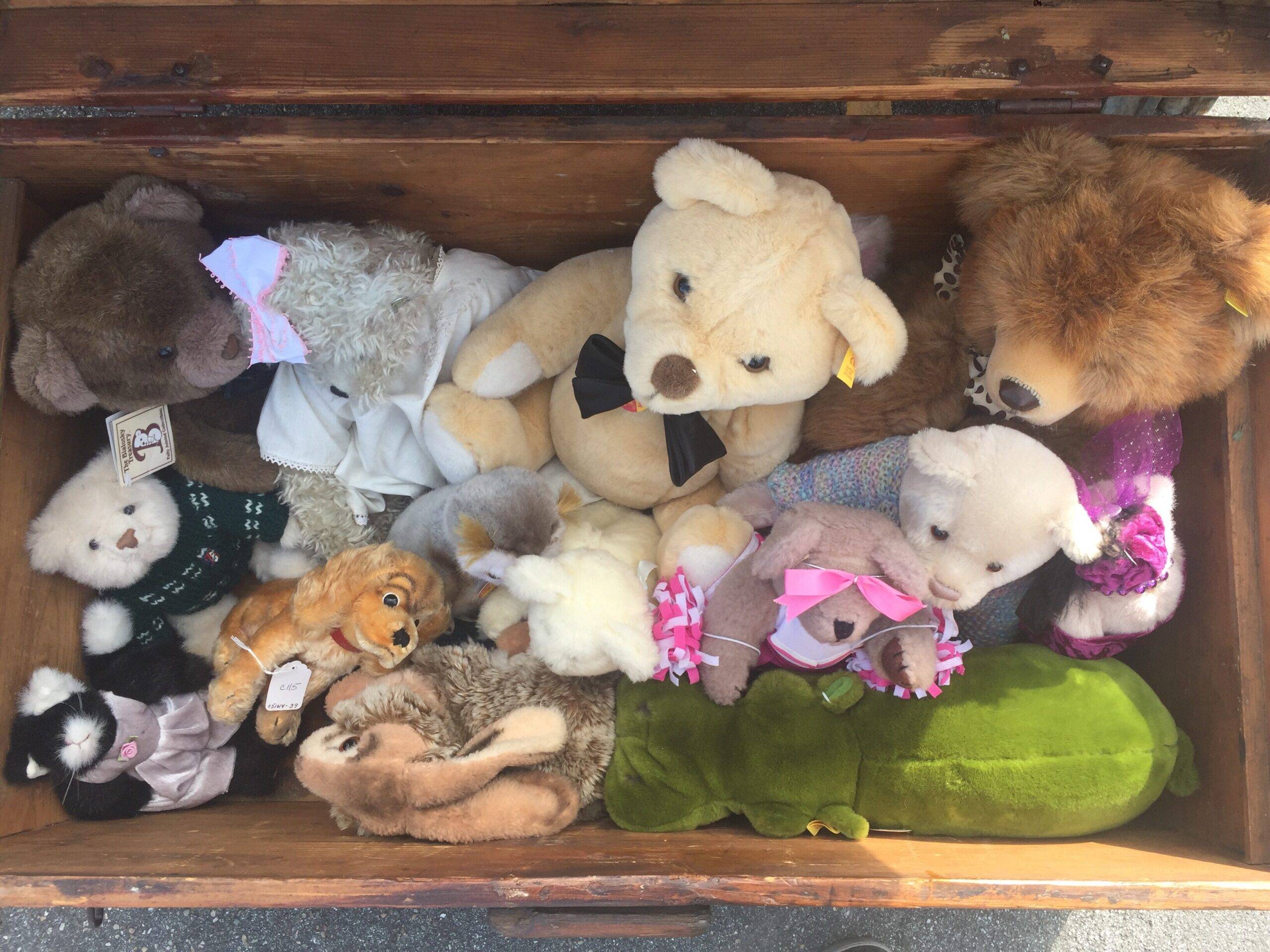 An above shot of an open trunk full of stuffed animals.