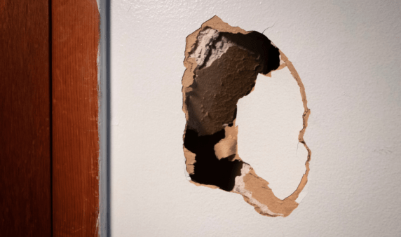 A hole in a section of drywall.