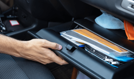 An open glovebox full of documents.