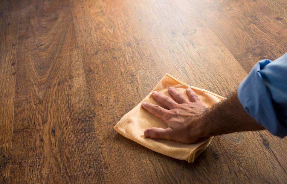 A person wiping a hardwood floor.