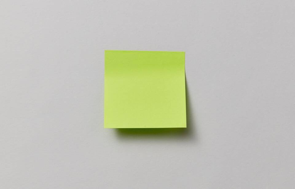 A blank post-it note on a wall.