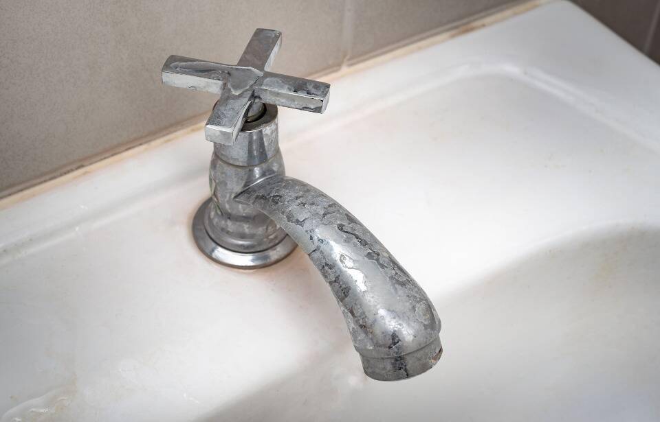 A hard-water stained faucet.