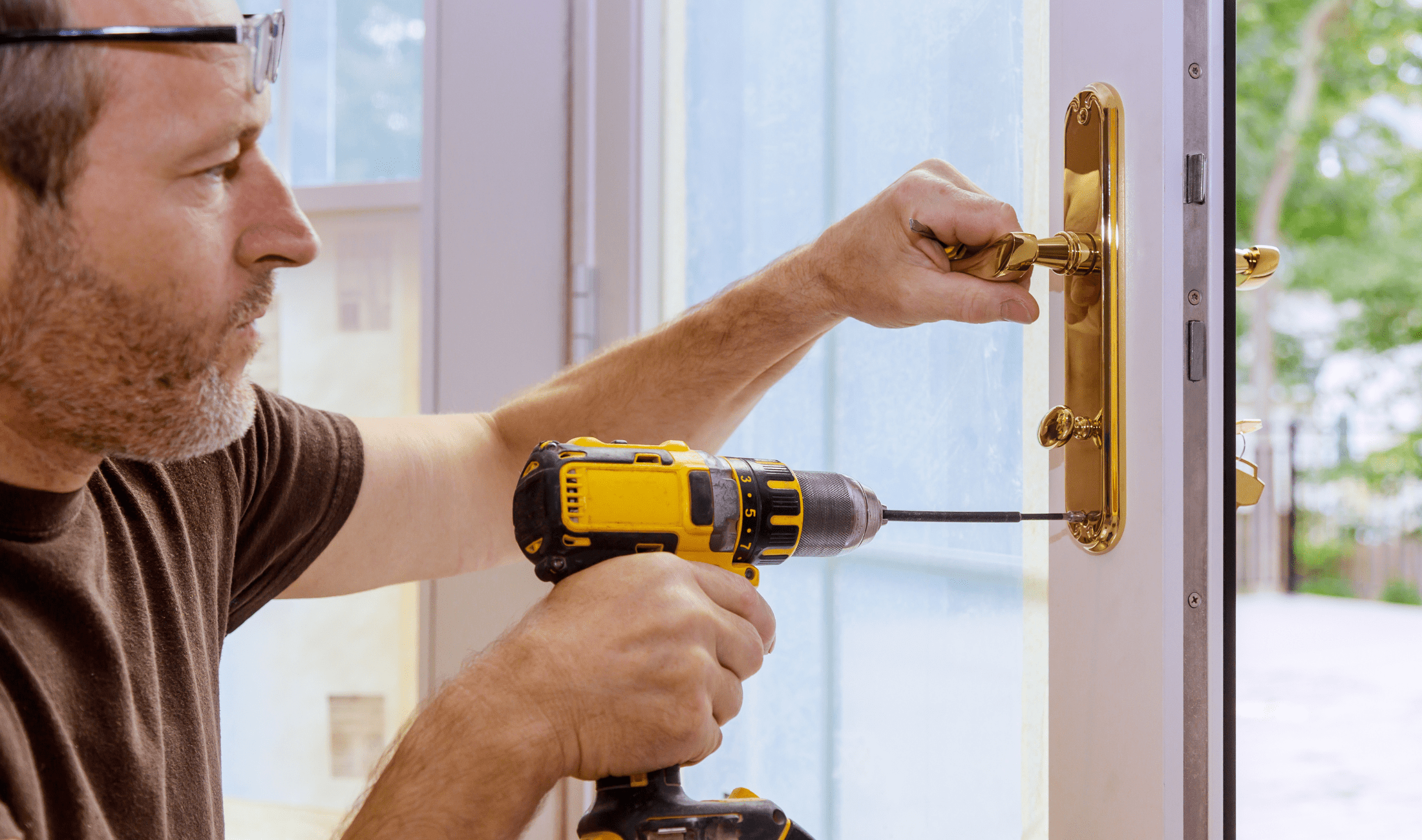 A man installing a lock on a door.