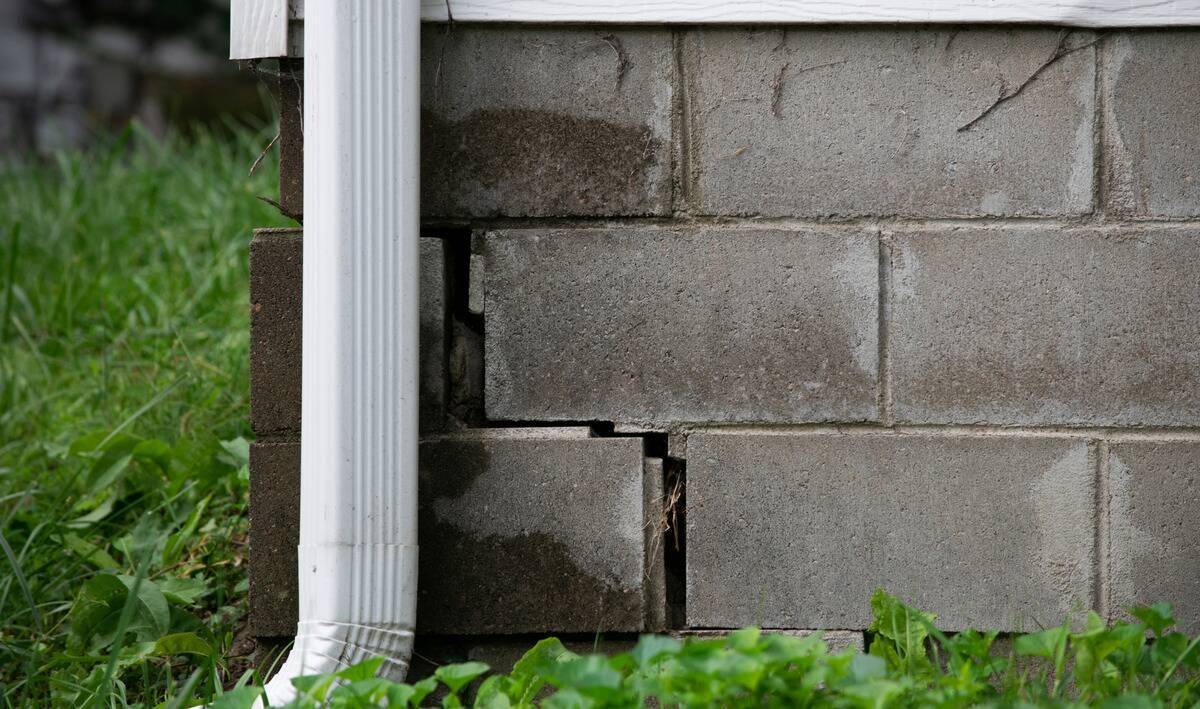 Two bricks in the foundation of a home whose joinery has cracked.