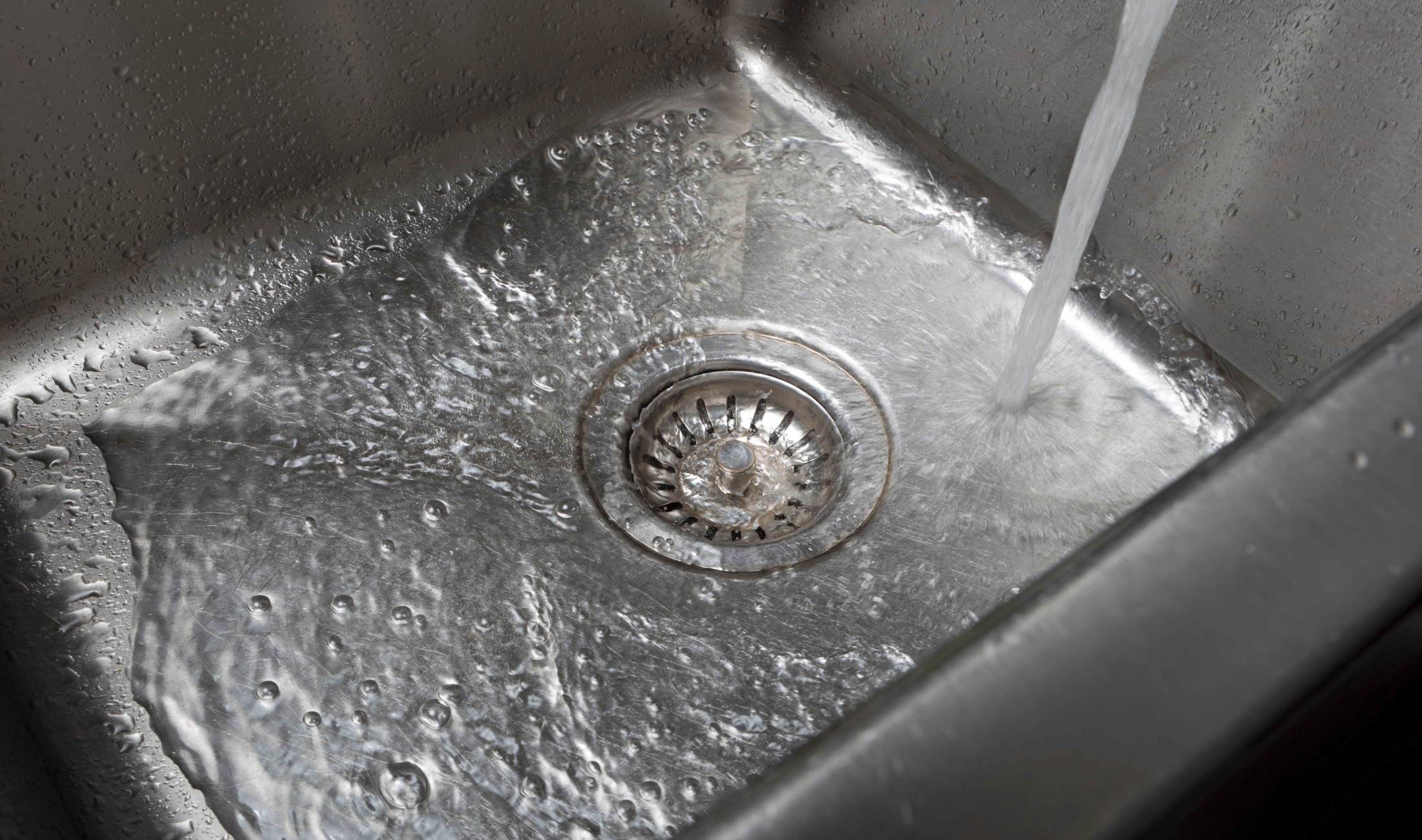 A sink running into the basin.