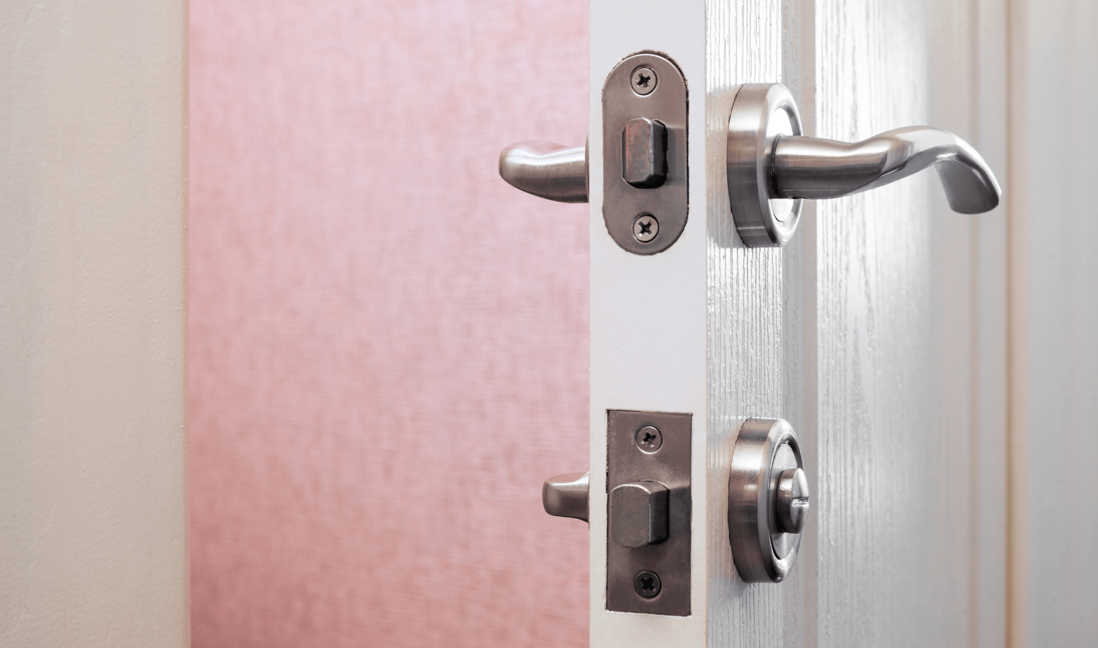 The side of a door, showing both the doorknob lock and the deadbolt under it.