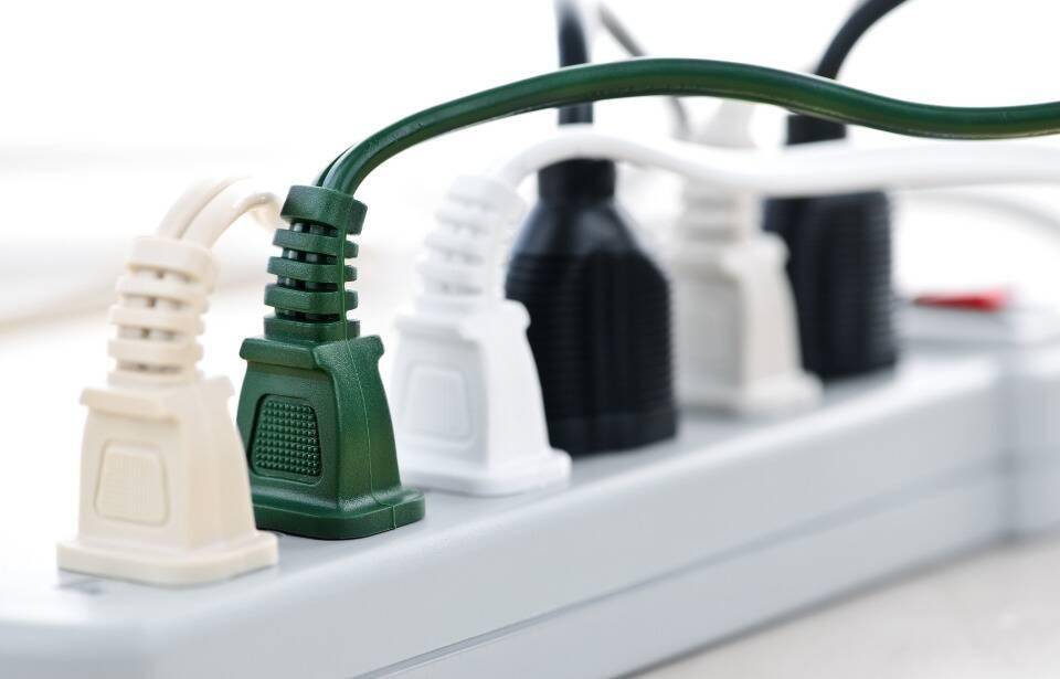 A surge protector full of plugs.