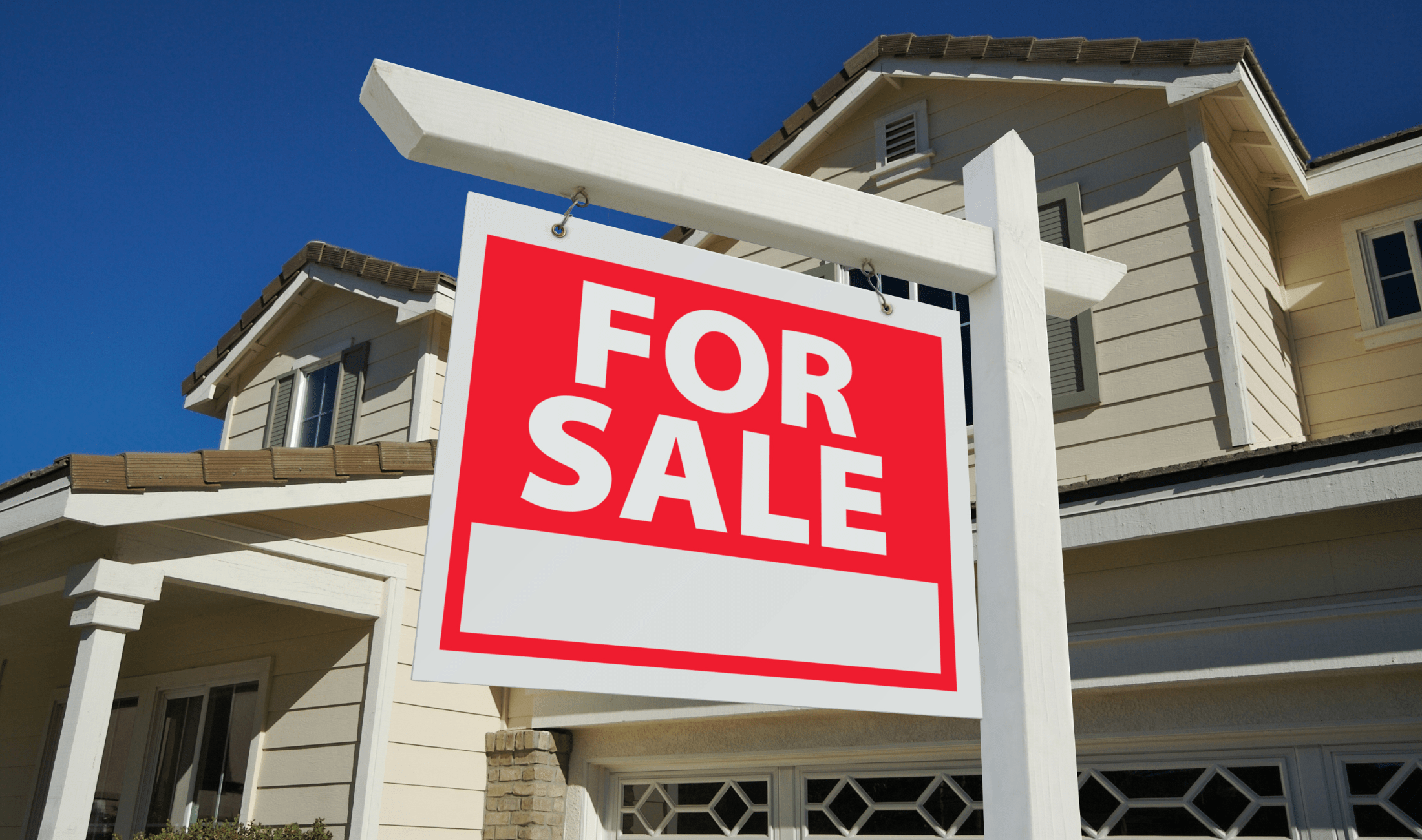 A large, red for sale sign in front of a house.