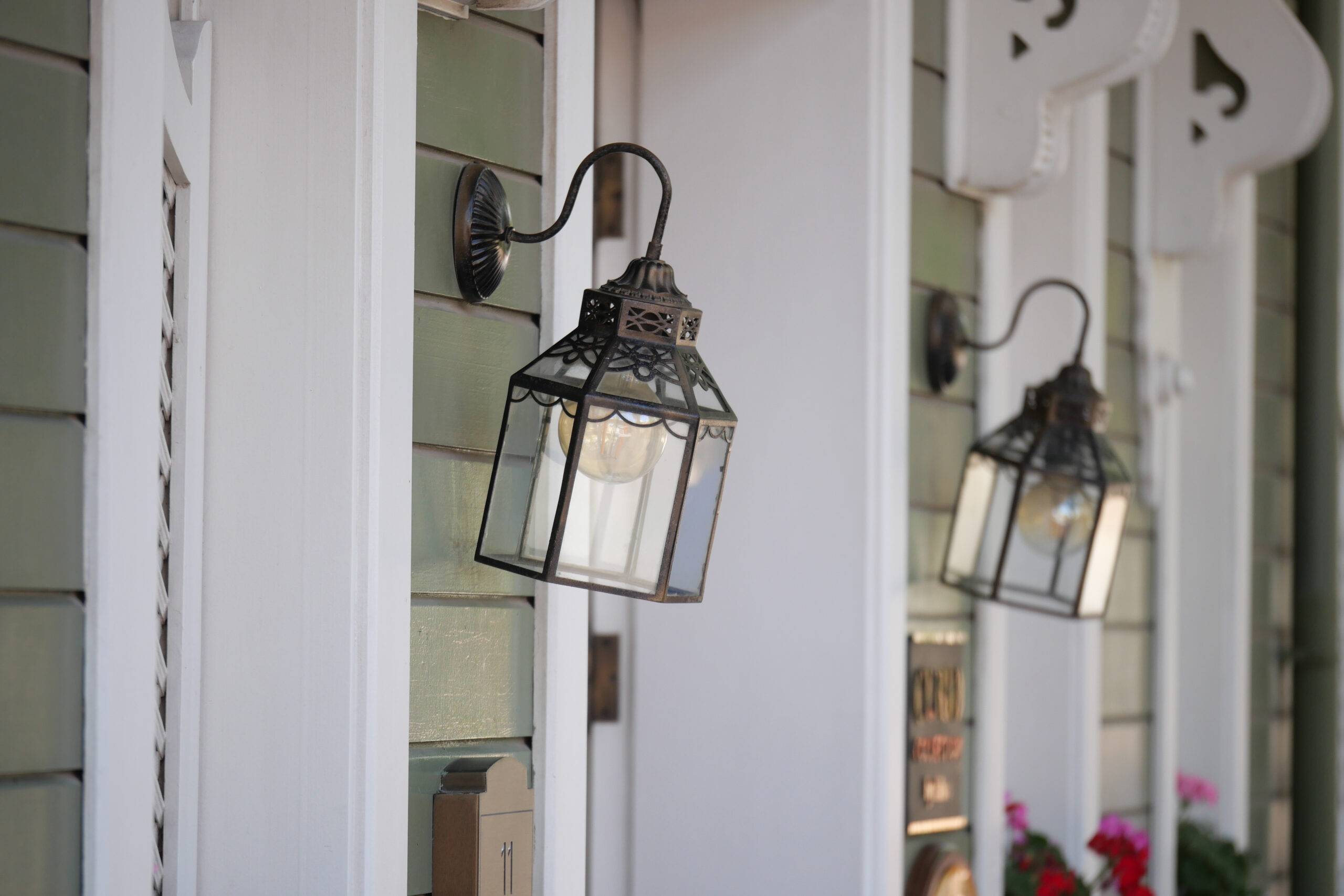 Lanterns illuminate the quaint entrance of a cozy building.