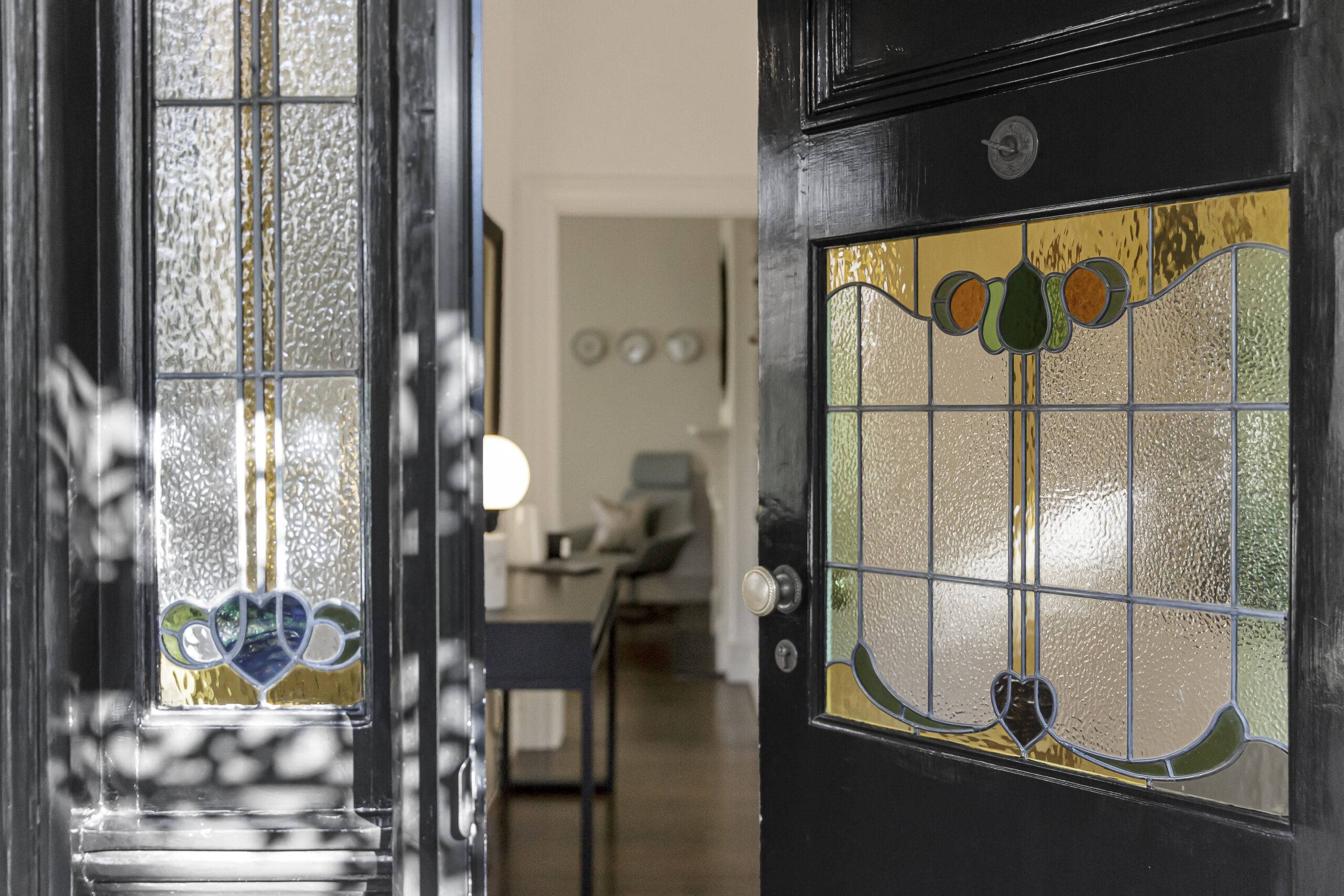 A close photo of the stained glass window of a door.