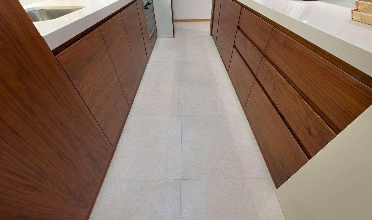 A narrow kitchen's tile floor.