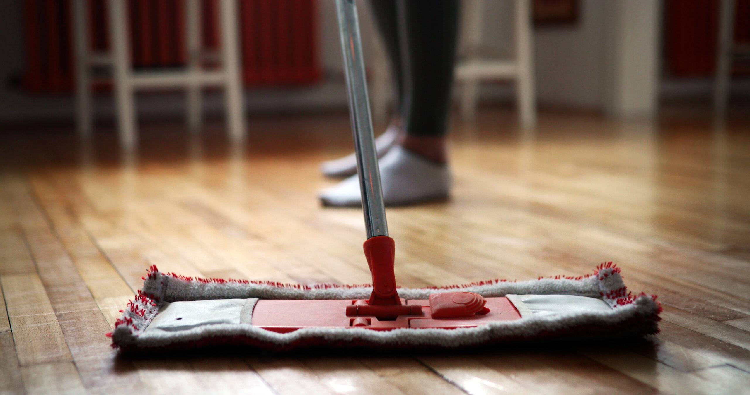 Woman using mop cleaner to do household chores faster and tidy home