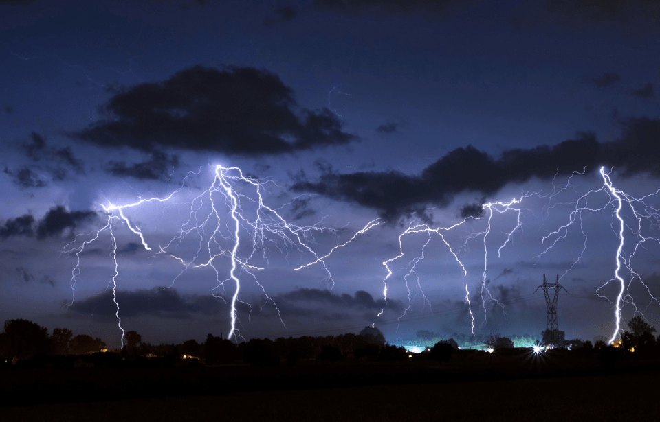 Lightening striking over a town.