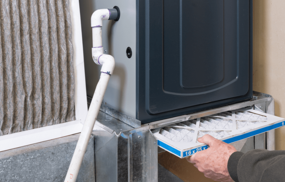 Person changing furnace filter.