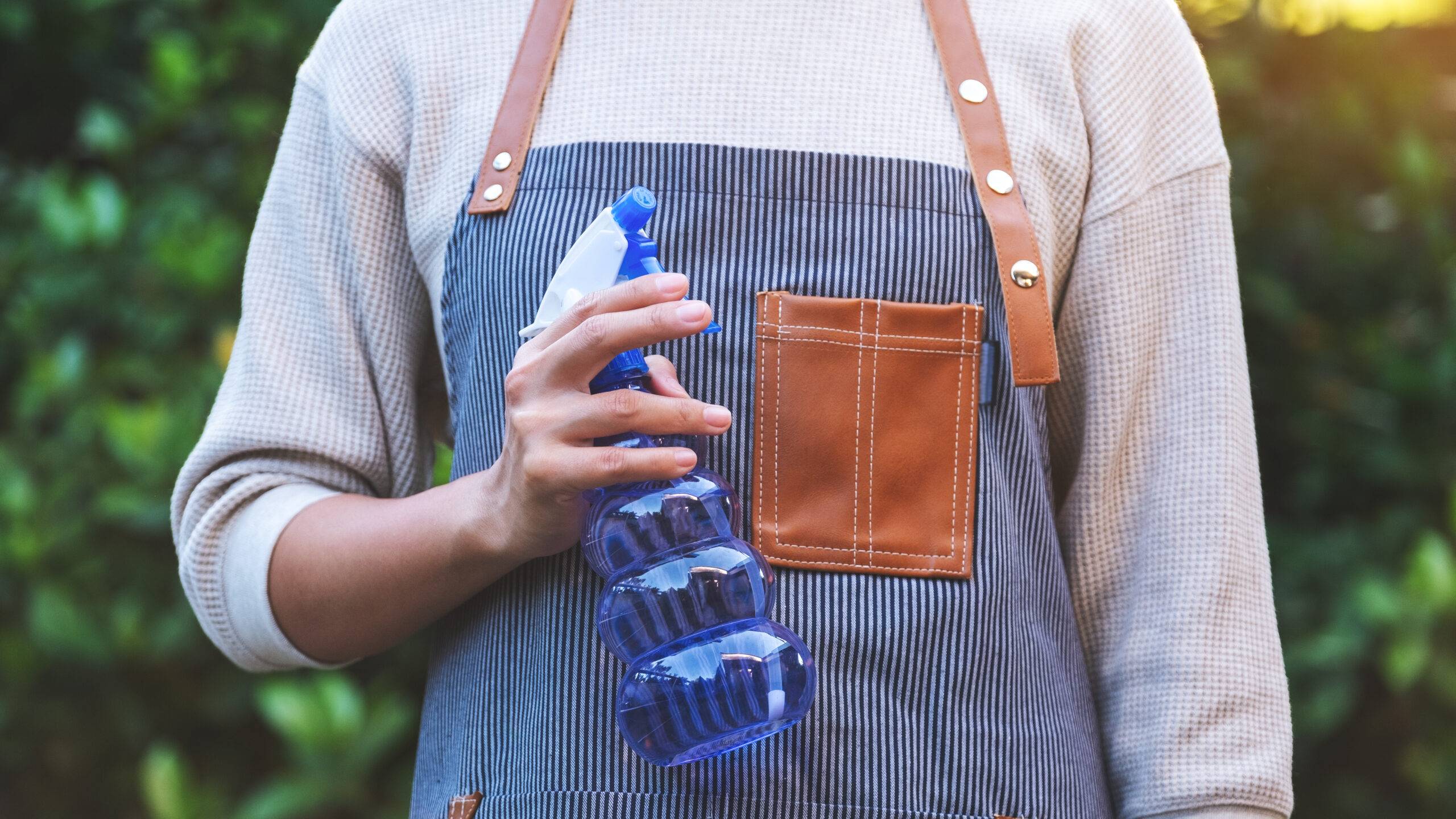 Woman holding spray bottle.
