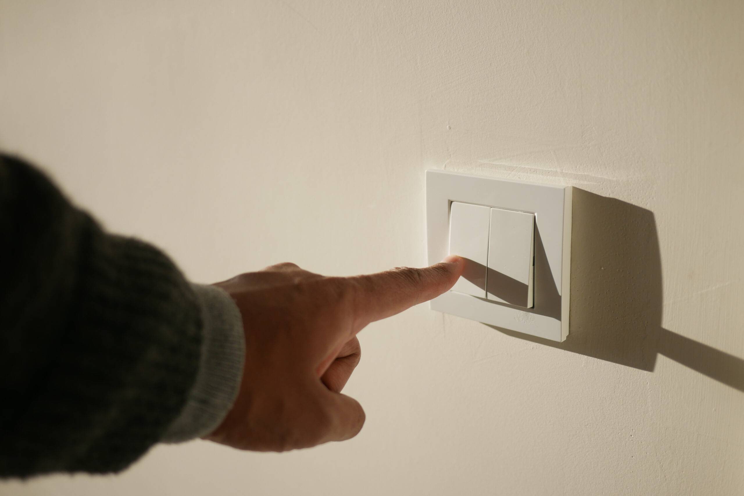 Turning off light switch.