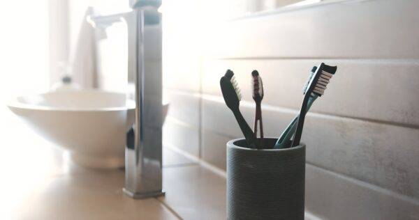 Toothbrushes in a cup in the bathroom.