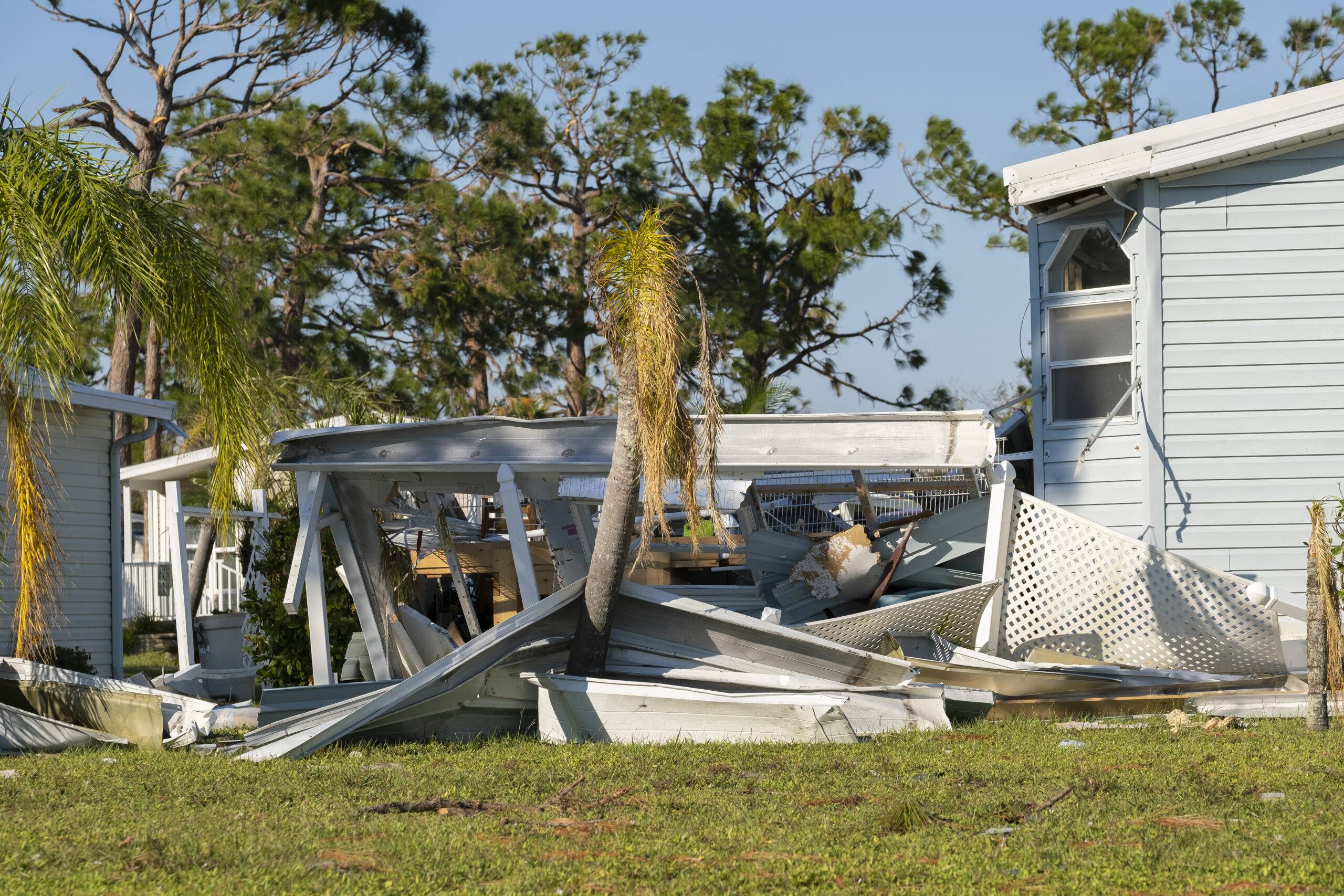 Damaged backyard structure after a hurricane.
