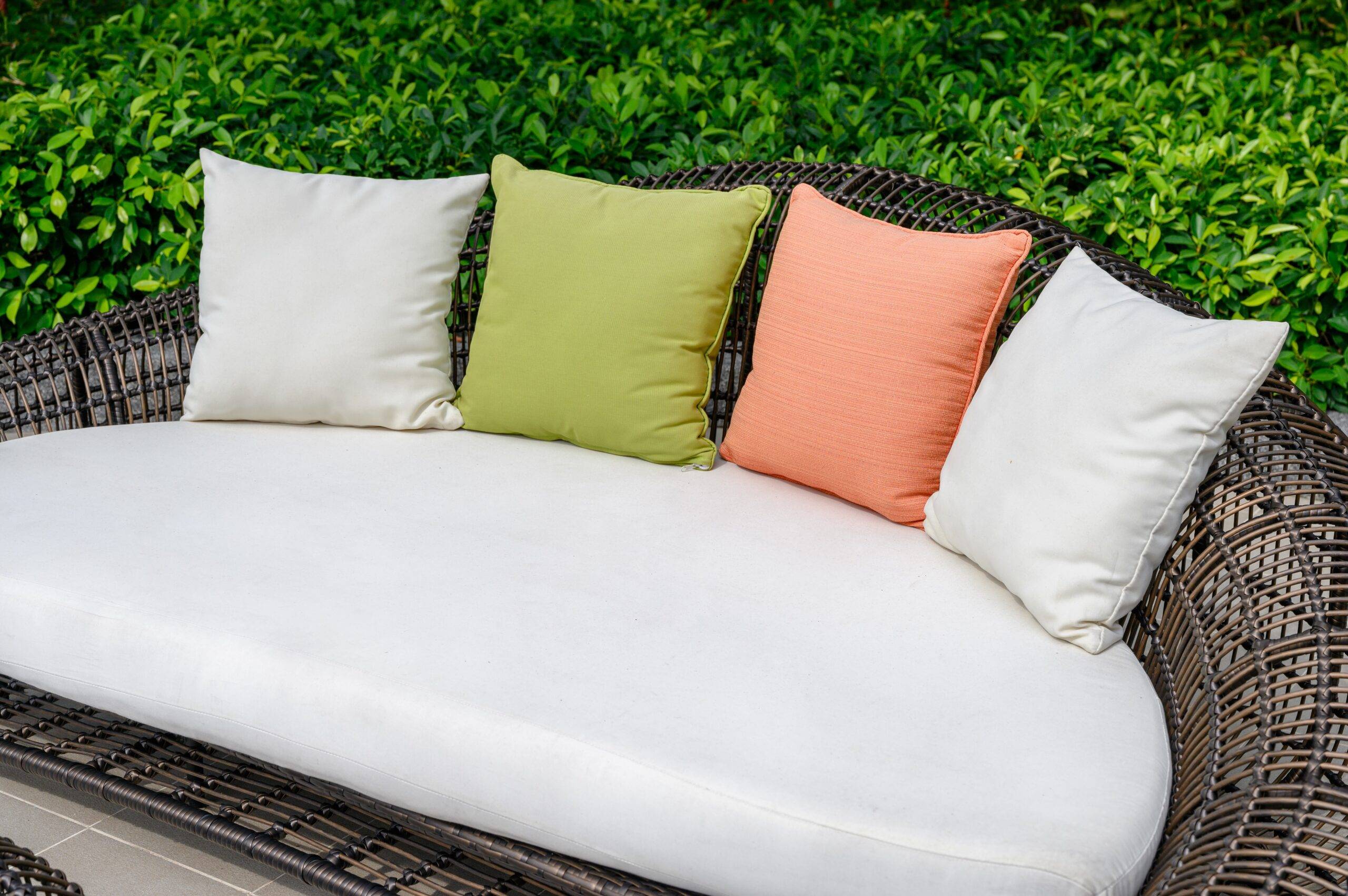 Pillows on mattress and weave wooden sofa in the garden