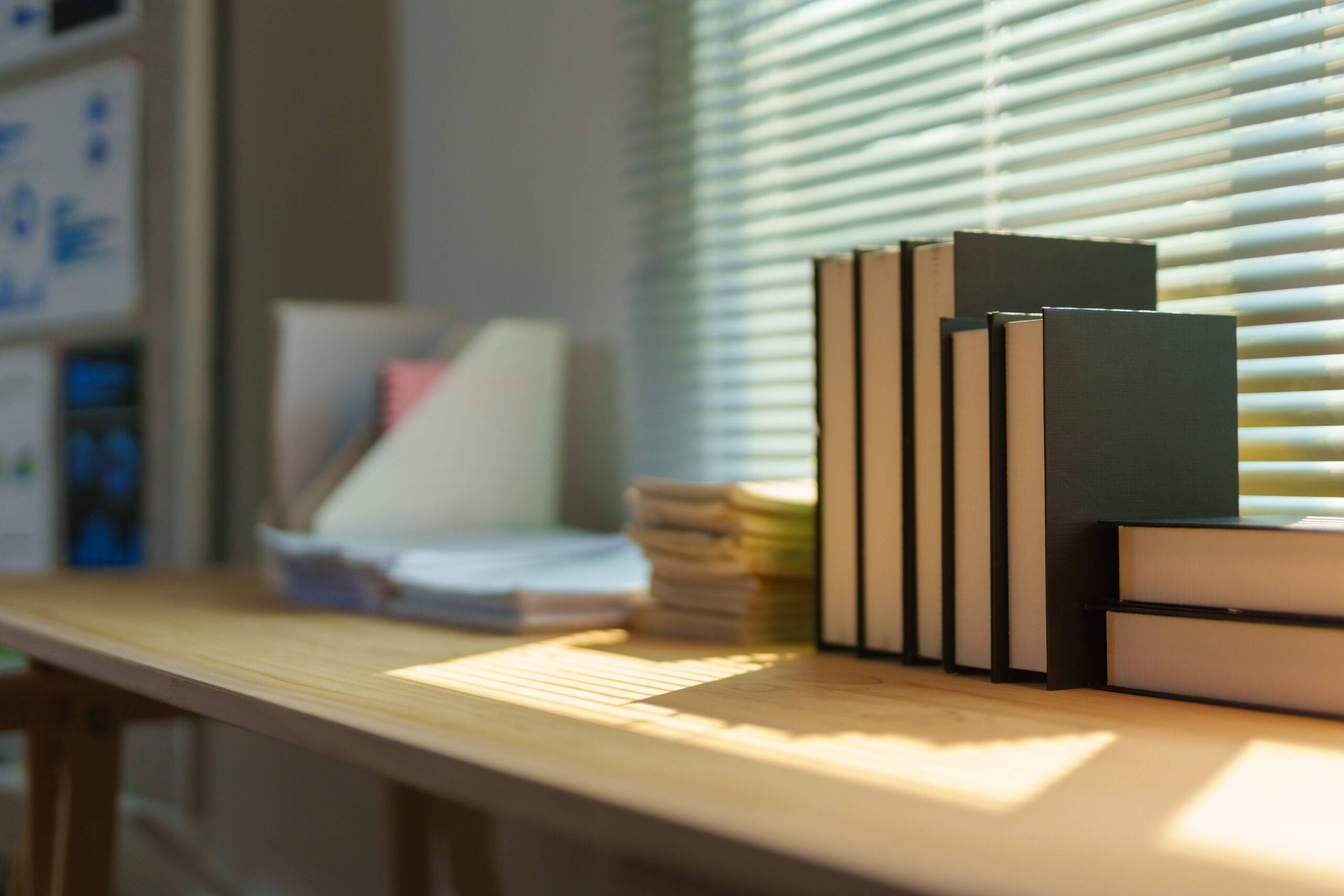 Sunlight through window falling on books.