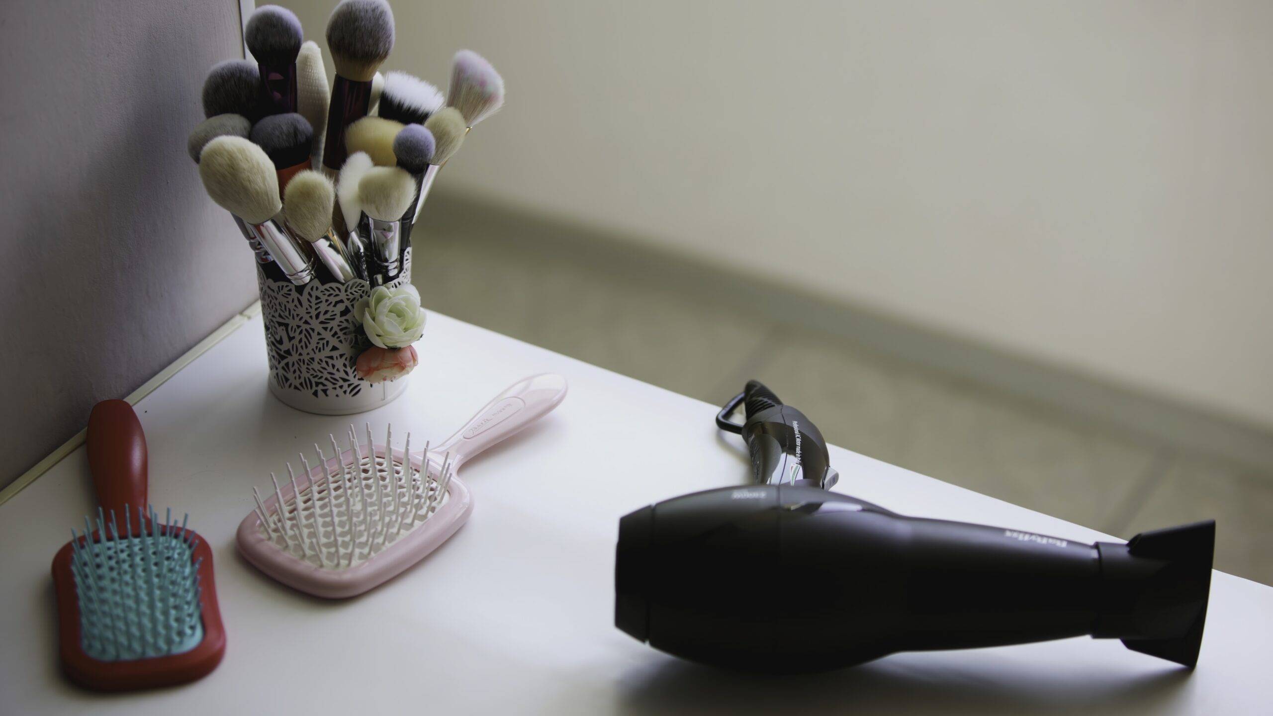 A hair dryer on a bathroom counter.