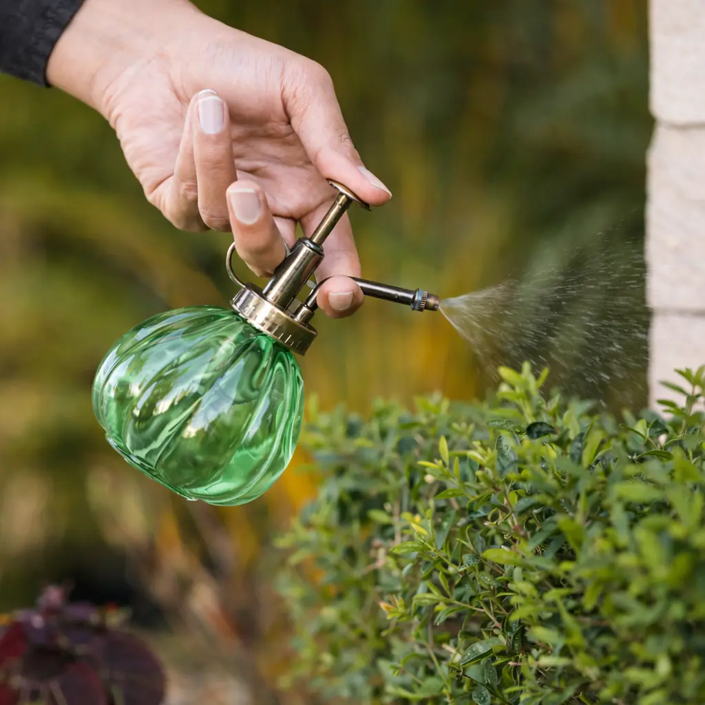 pepper being sprayed onto plants to keep pests away.