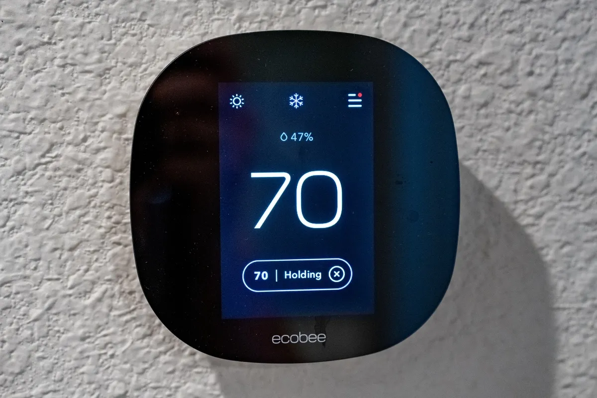 Smart thermostat on a wall, showing a temperature of 70 degrees, Murphys, California, August 3, 2025
