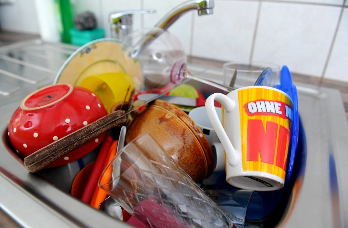 Dishes piled in the sink.