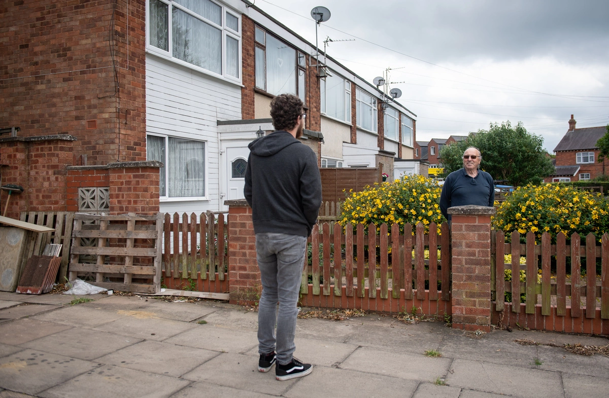 Coronavirus - Thu Jul 2, 2020David Blohm (right) talks to his neighbour Jack Gutteridge across the fence from his home on Telford Way in Leicester.
