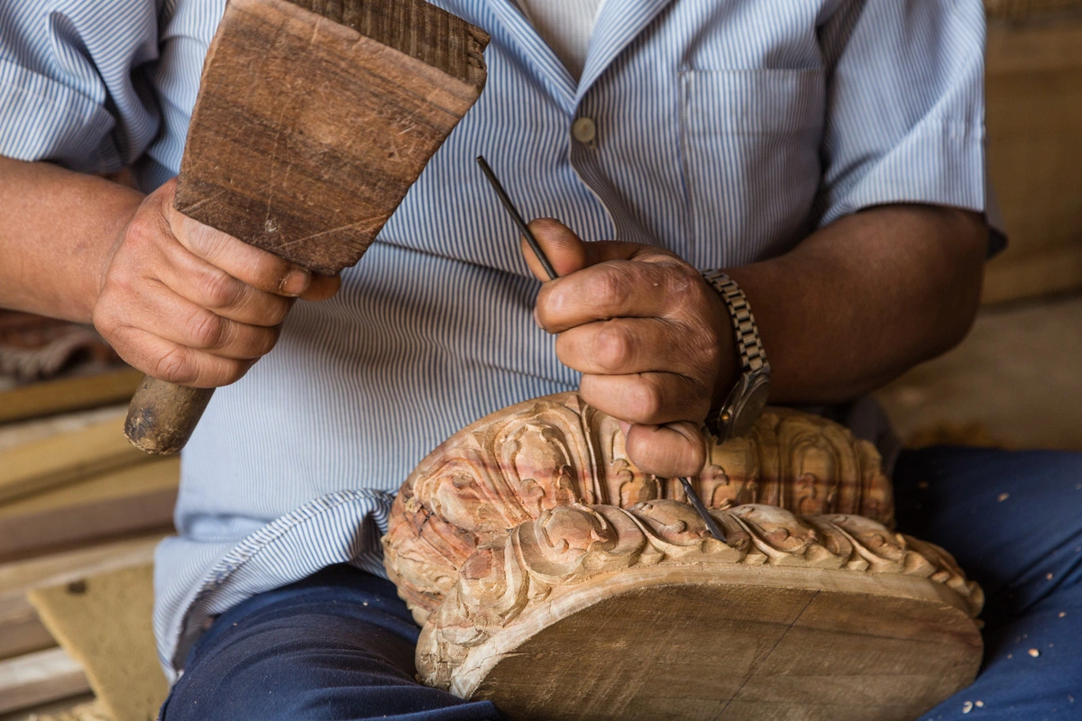 A man carving wood.