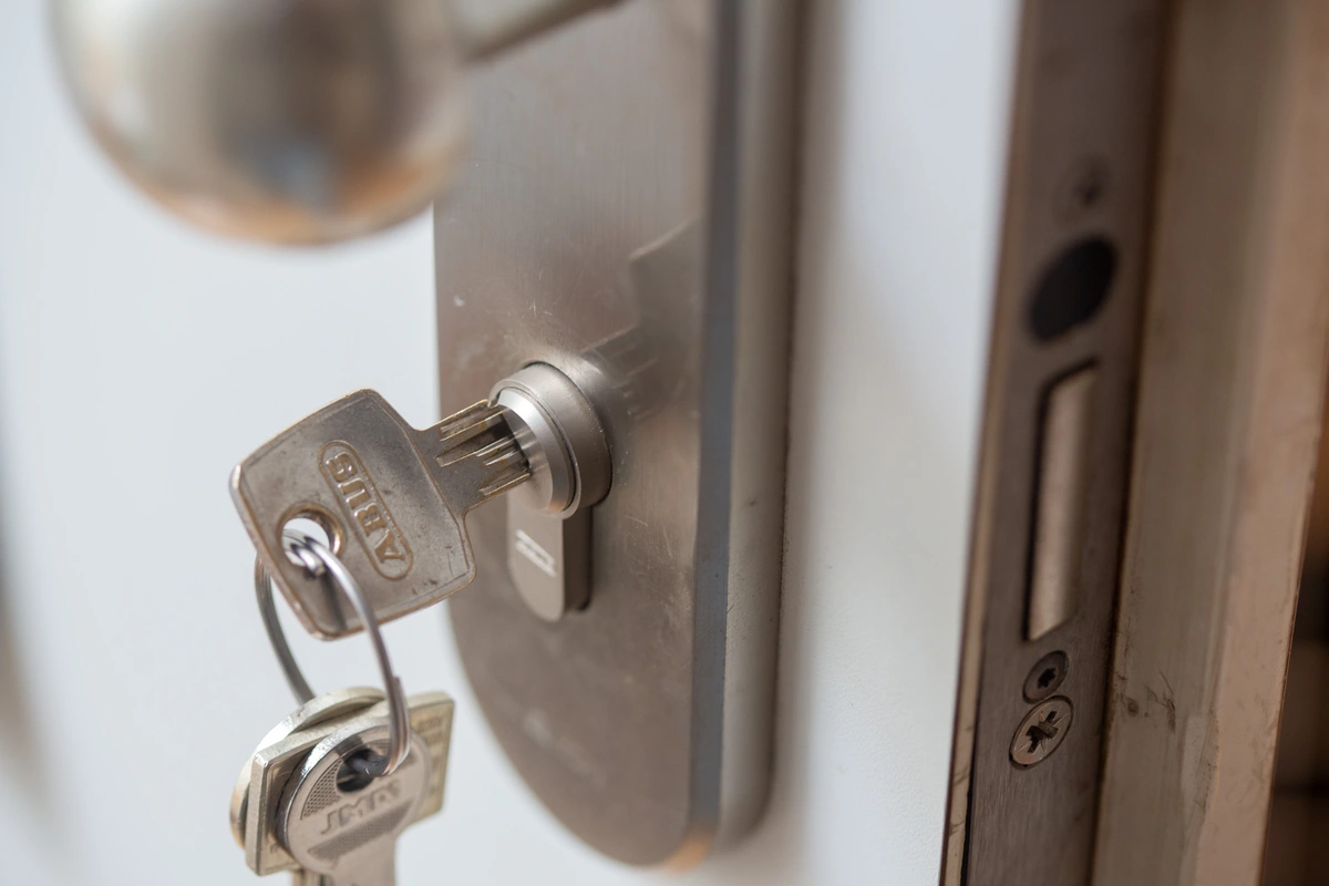 A key inserted in an apartment door lock.